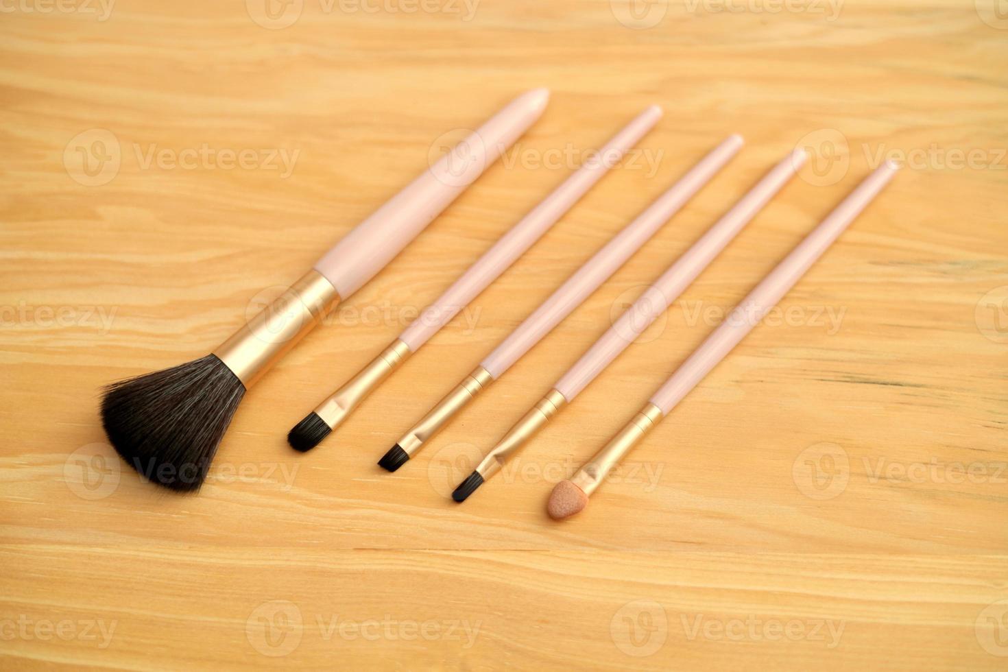 Set of makeup brushes with Wood Background photo