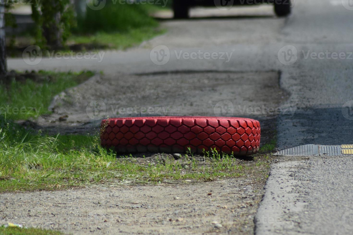 Red tread wheels on the side of  road photo