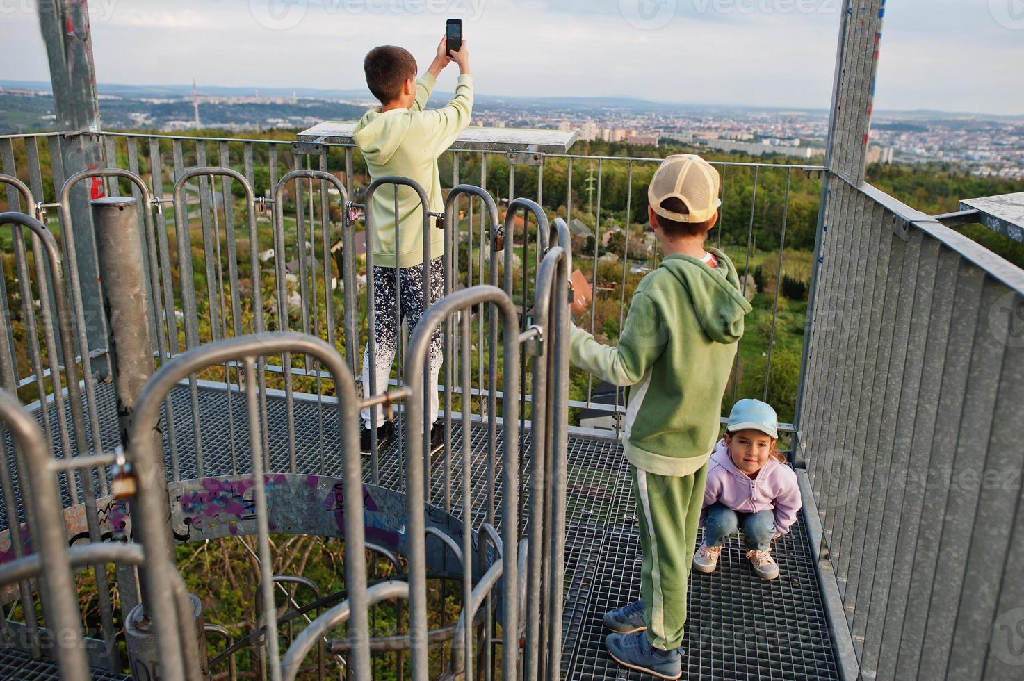 Kids at viewing tower. Watchtower during sunset. photo