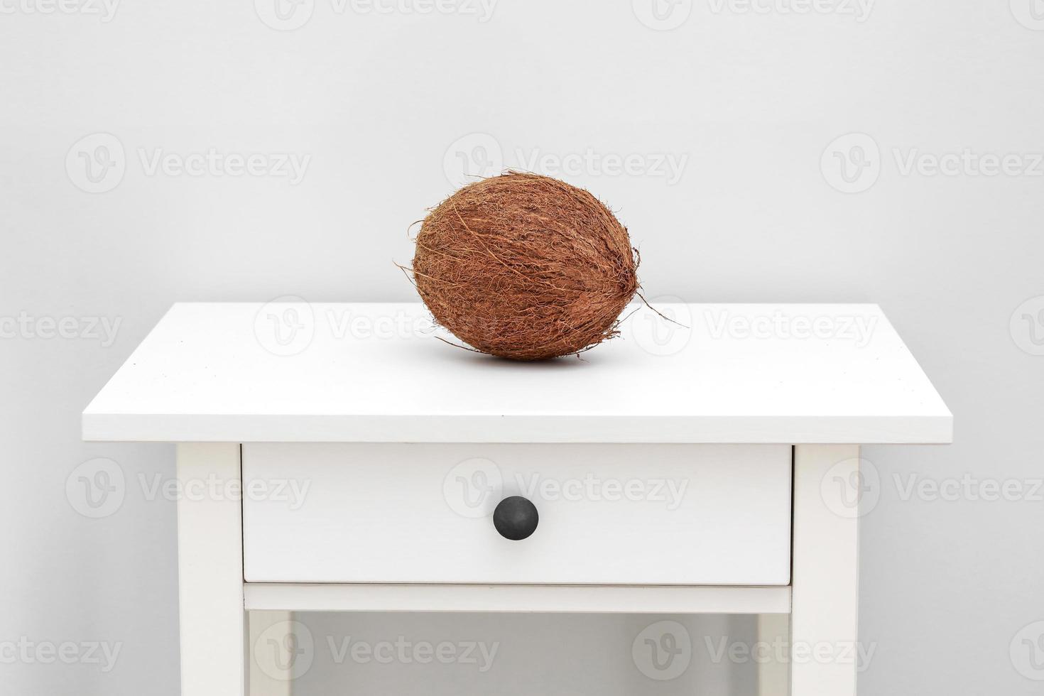 Homemade coconut products on white wooden table background. whole coconut on white table. Summer tropical concept photo