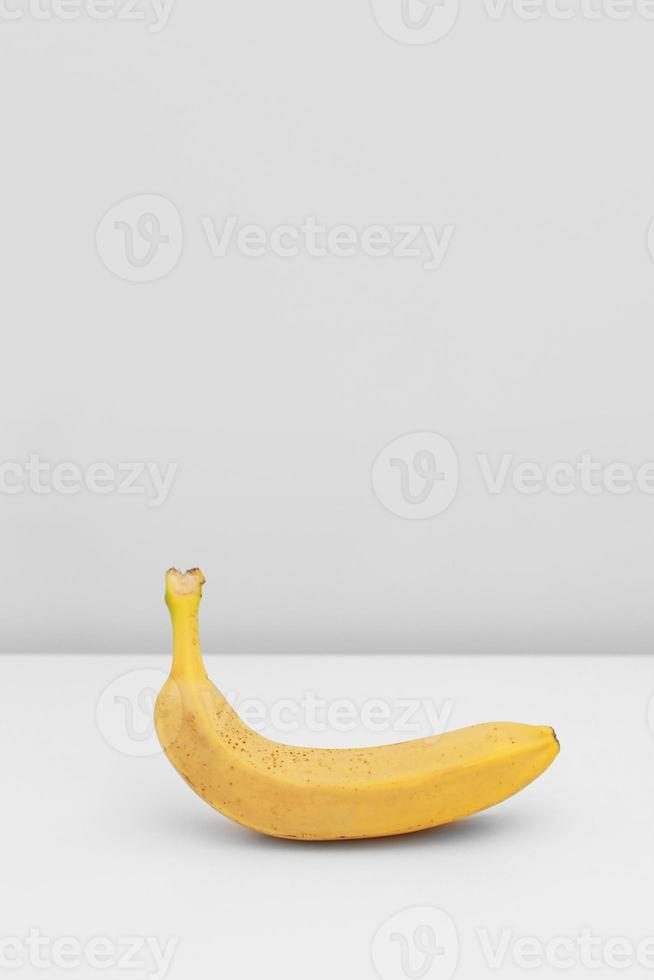 Single yellow ripe banana isolated on white background. Fiber fruits photo