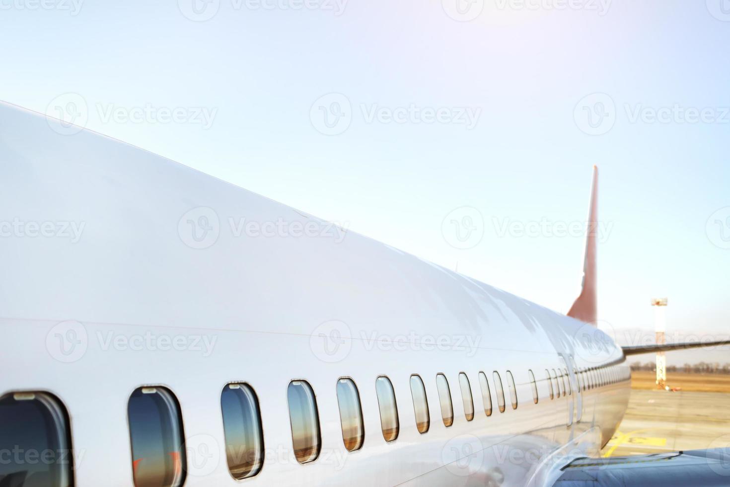 Airplane being preparing ready for takeoff in international airport at sunset - Travel around the world. High quality photo