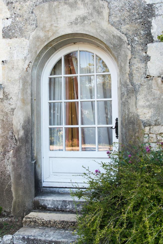 Traditional entrance with a wooden and glass door. photo