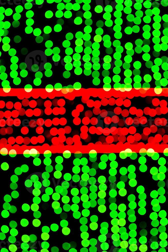 Unfocused abstract green and red bokeh on black background. defocused and blurred many round light photo