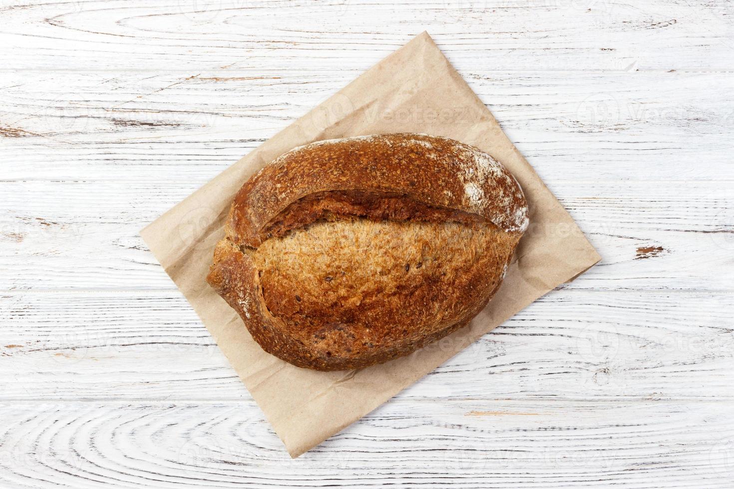 Loaf of bread on a grocey paper bag in european style. top view photo