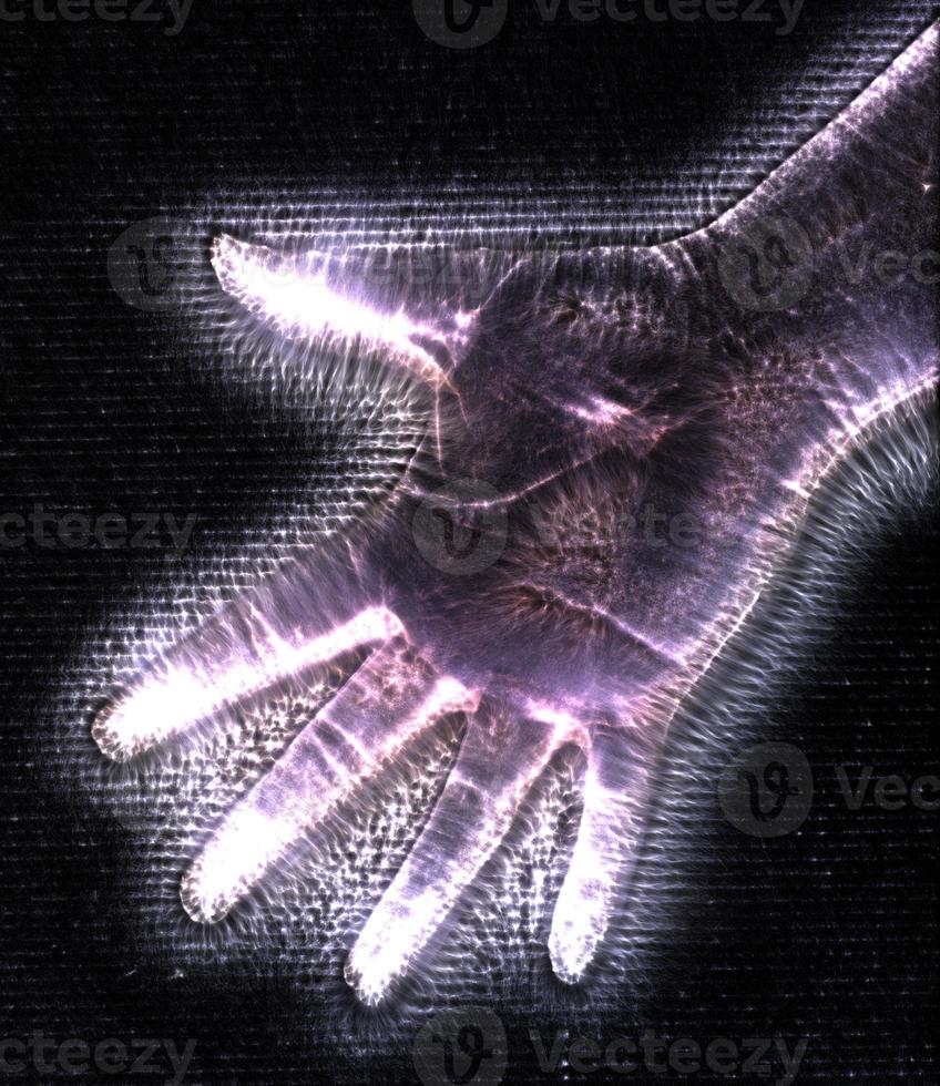 3D-Illustration of a glowing human female hand with a kirlian aura showing different symbols photo