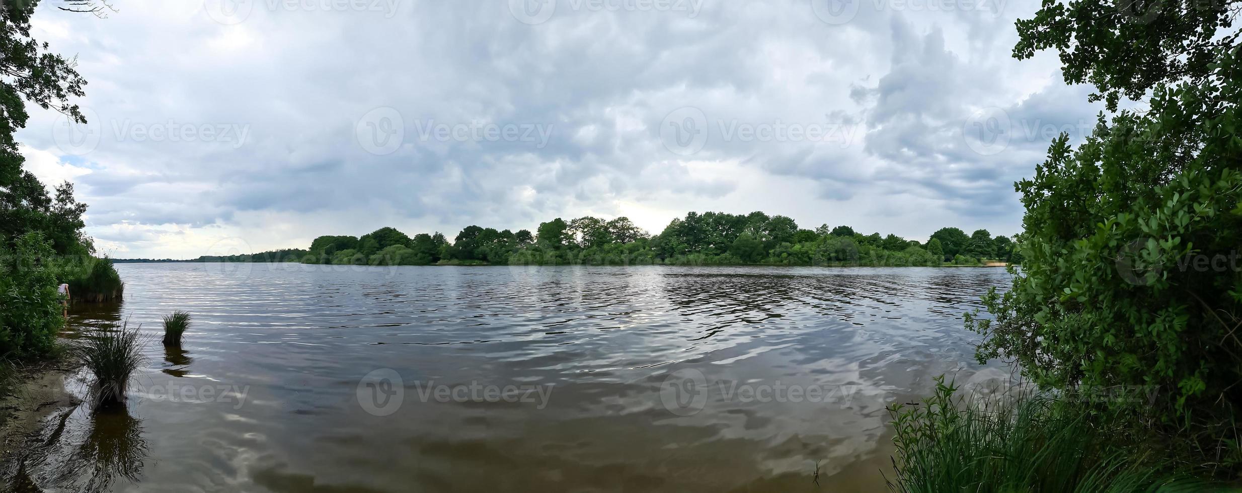 Beautiful landscape at a lake with a reflective water surface photo