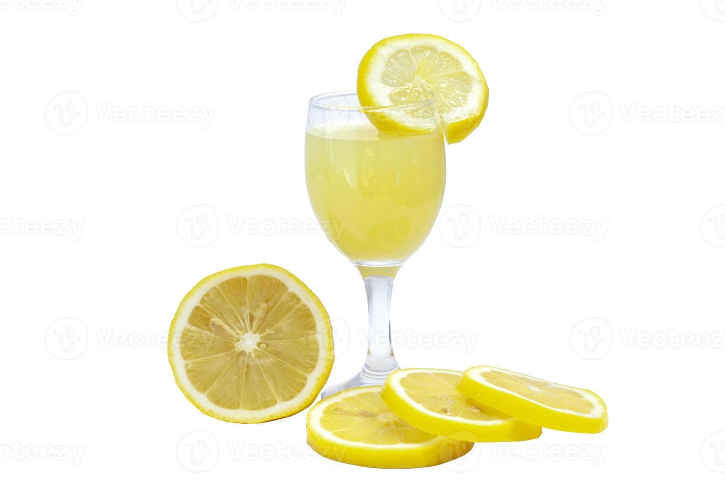 Lemonade in glass and sliced pieces lemons isolated on white background. photo