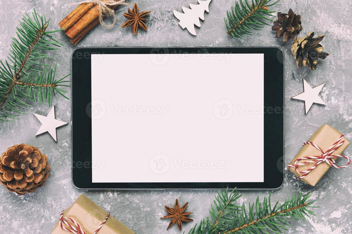 Digital tablet mock up with rustic Christmas gray cement background decorations for app presentation. top view with copy space. Toned photo