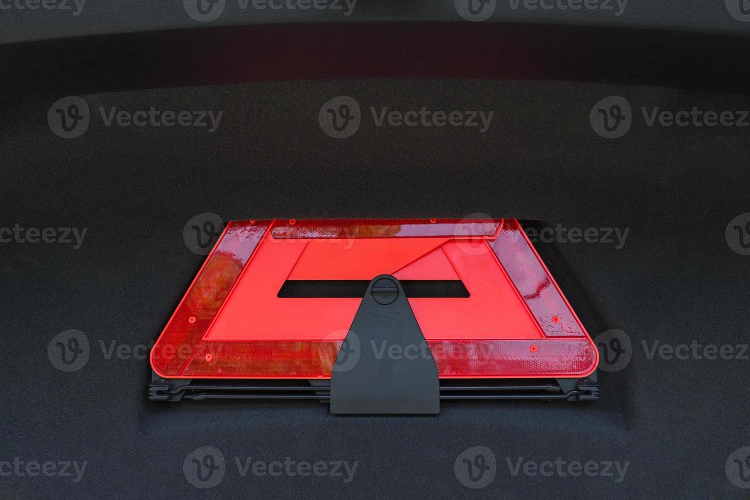 A red folded emergency sign lies in the trunk. photo