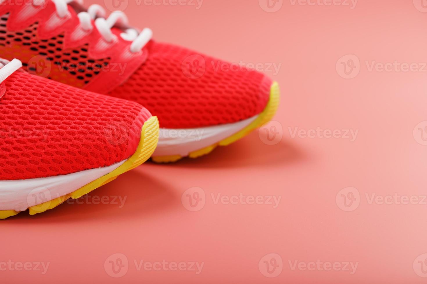 Sports pink sneakers on a pink background with free space. photo