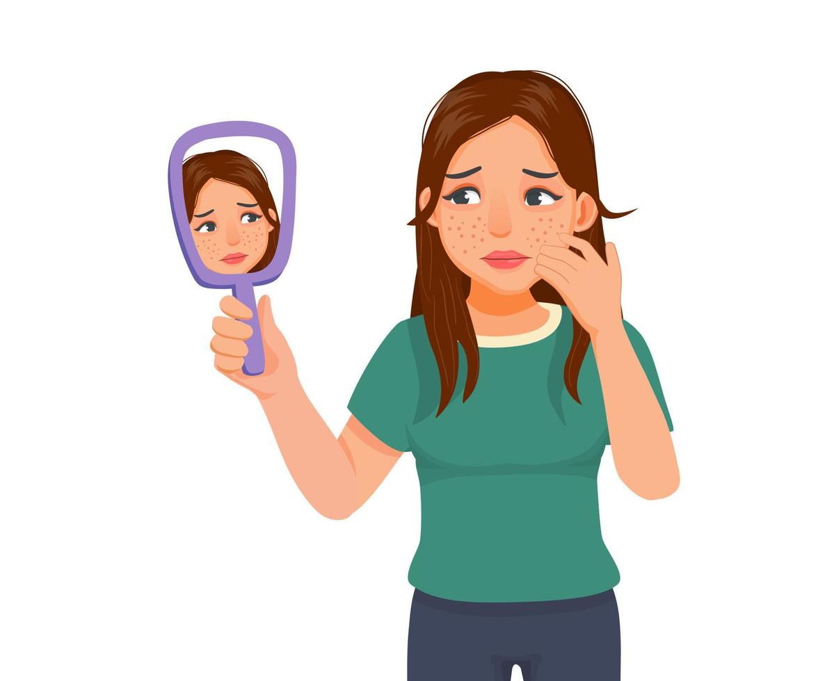 Anxious young woman holding mirror looking at acne spot pimples on her face vector