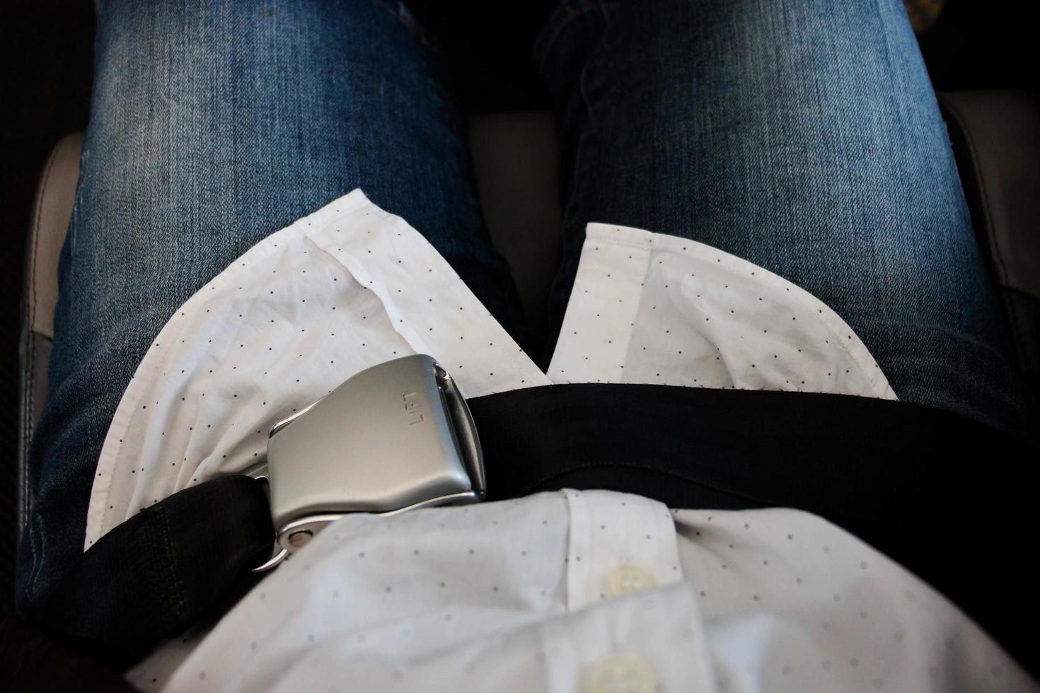 locked airplane seat belt over passenger lap 13171044 Stock Photo at