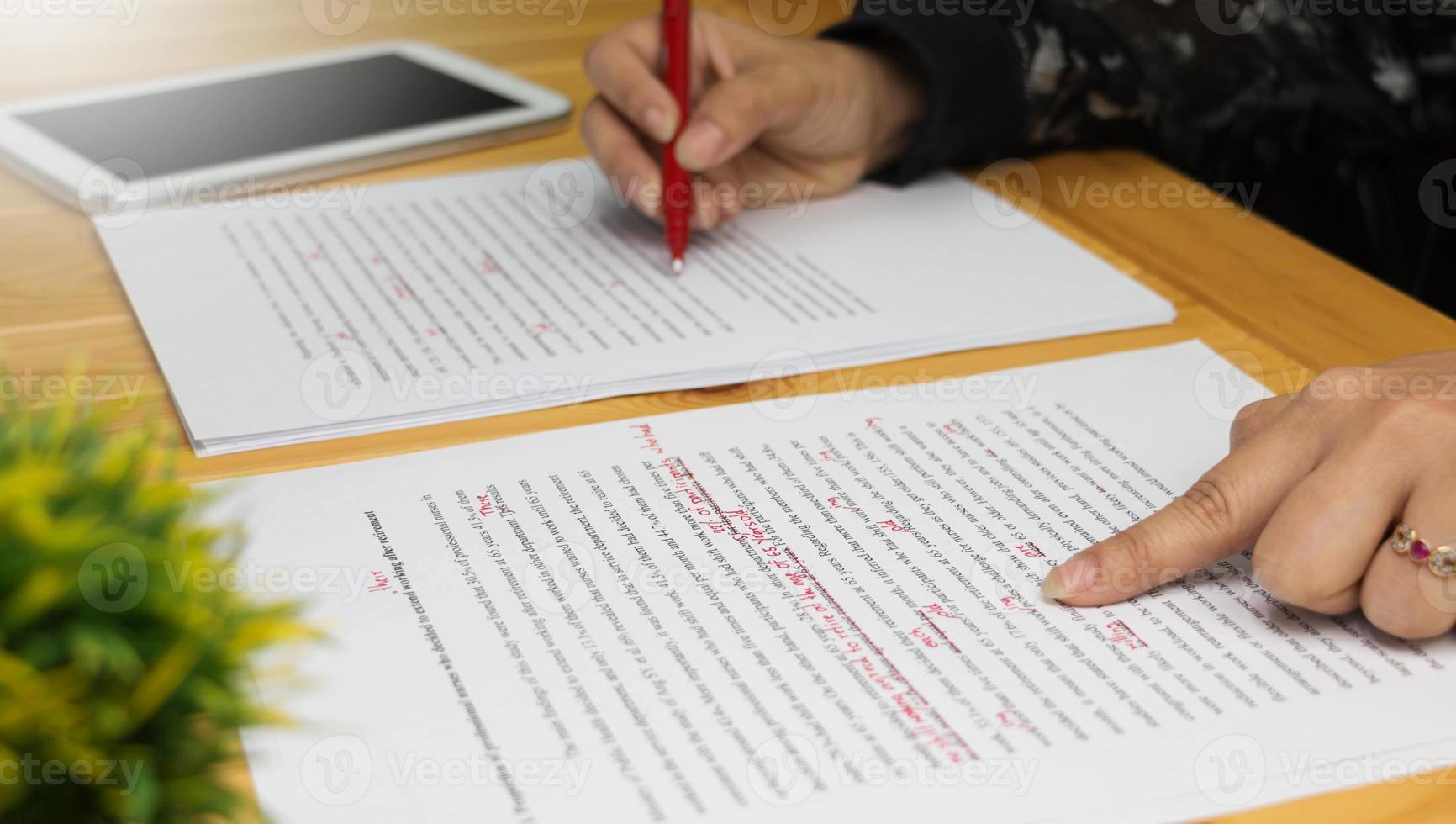 proofreading paper on table photo