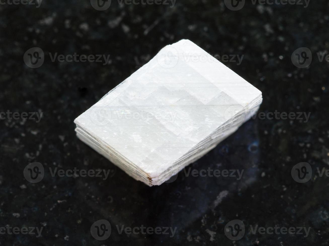 raw white calcite stone on dark background photo