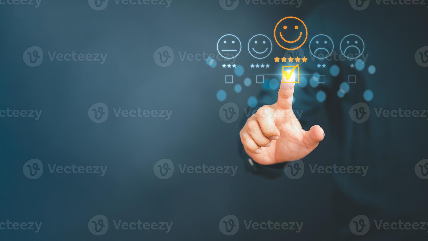Man touching the virtual screen on the happy smiley face icon to give satisfaction in service. Rating very impressed. Customer service and satisfaction concept. photo