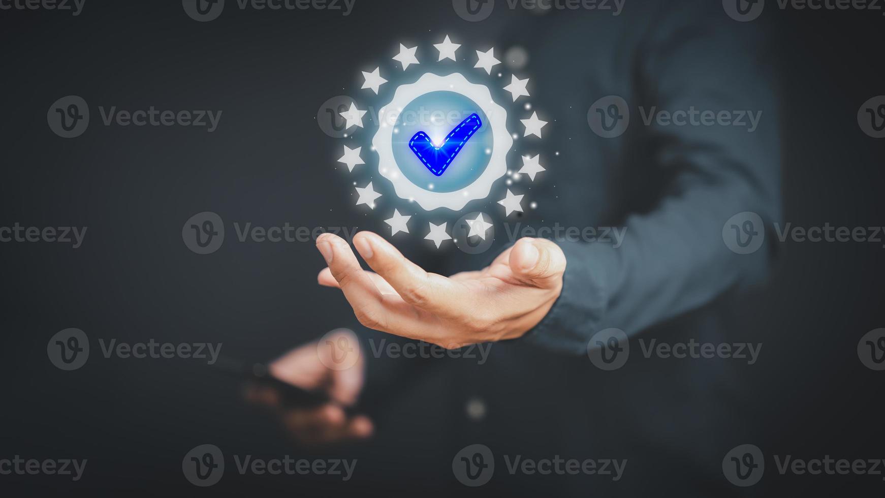 Quality assurance of business services, Businessman holding and showing the best quality assurance with golden five stars. Guarantee, Standards, ISO certification and testimonail concept. photo