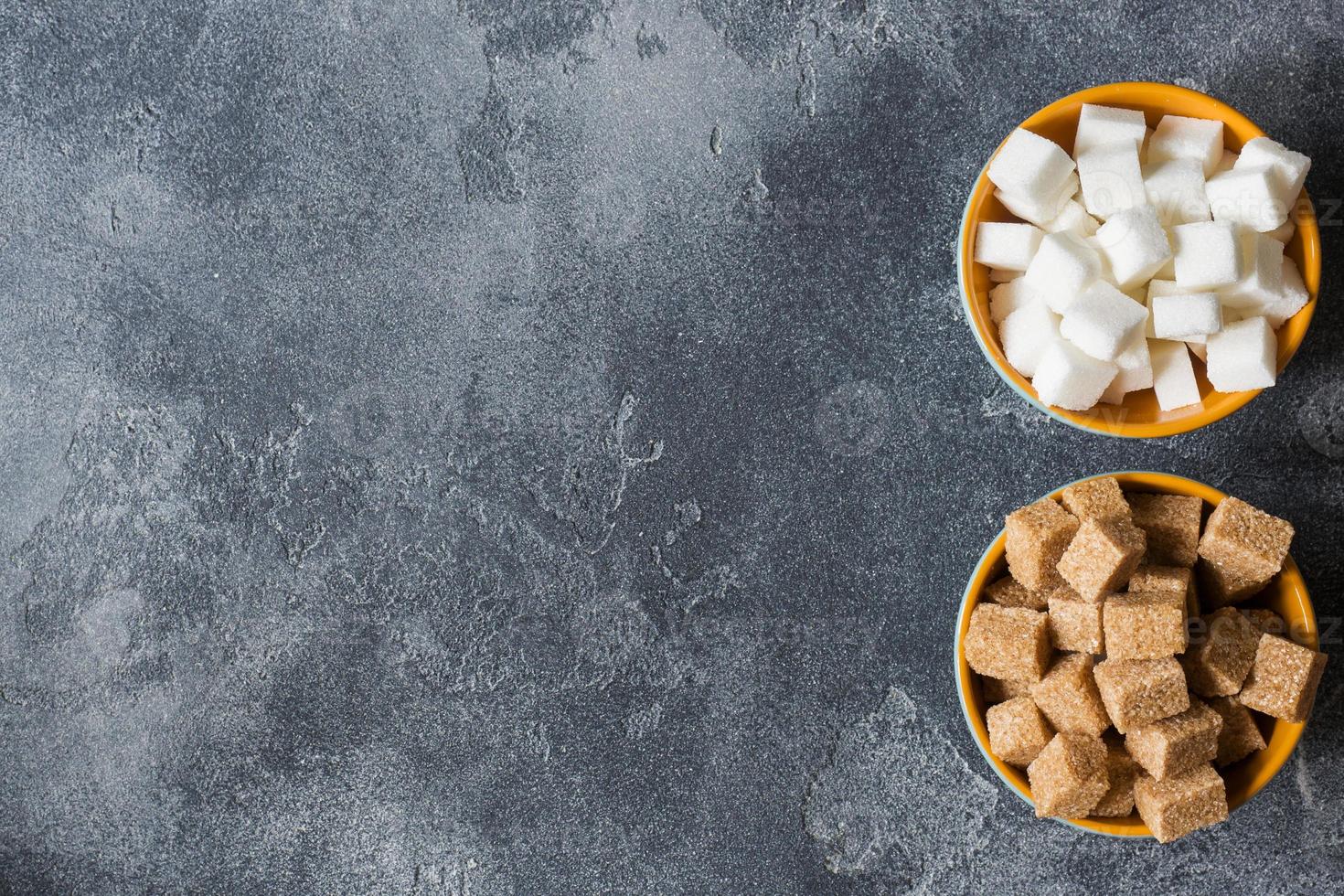 White sugar and brown sugar cane cube on the dark background of the brutal Selective focus photo