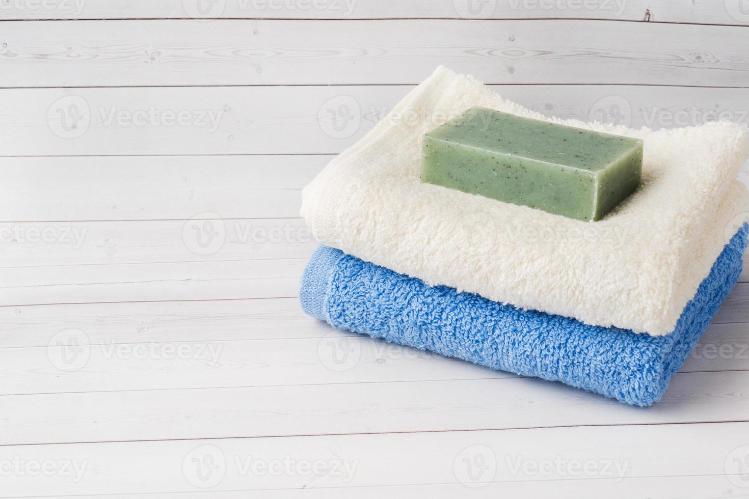 Spa and Wellness concept on white background. Towels cream soap and bath accessories. Copy space photo