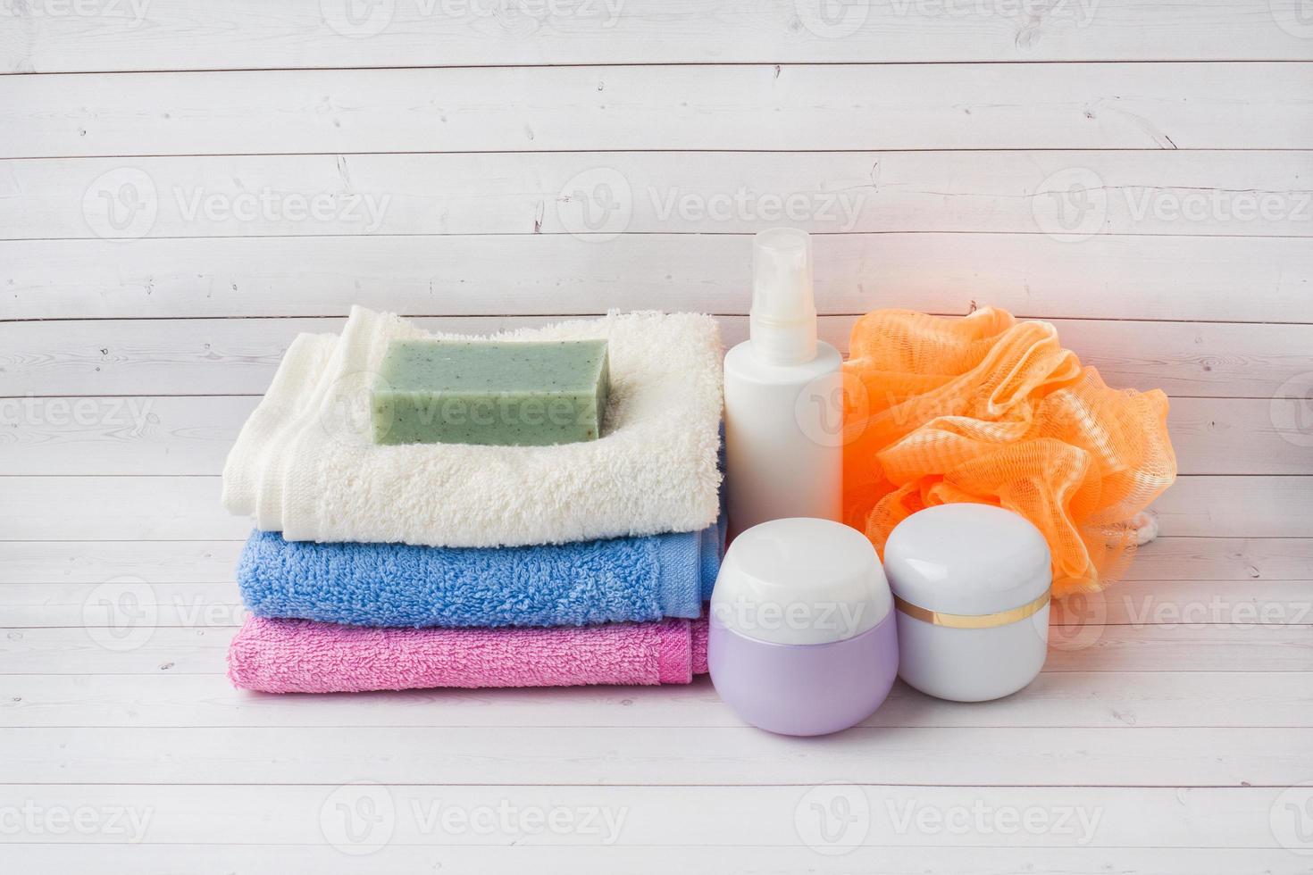 Spa and Wellness concept on white background. Towels cream soap and bath accessories. photo