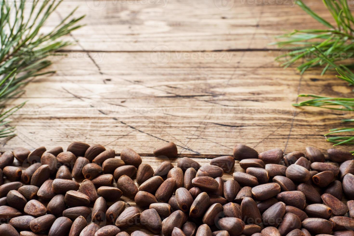 Pine nuts on a wooden background. Selective focus. Copy space photo