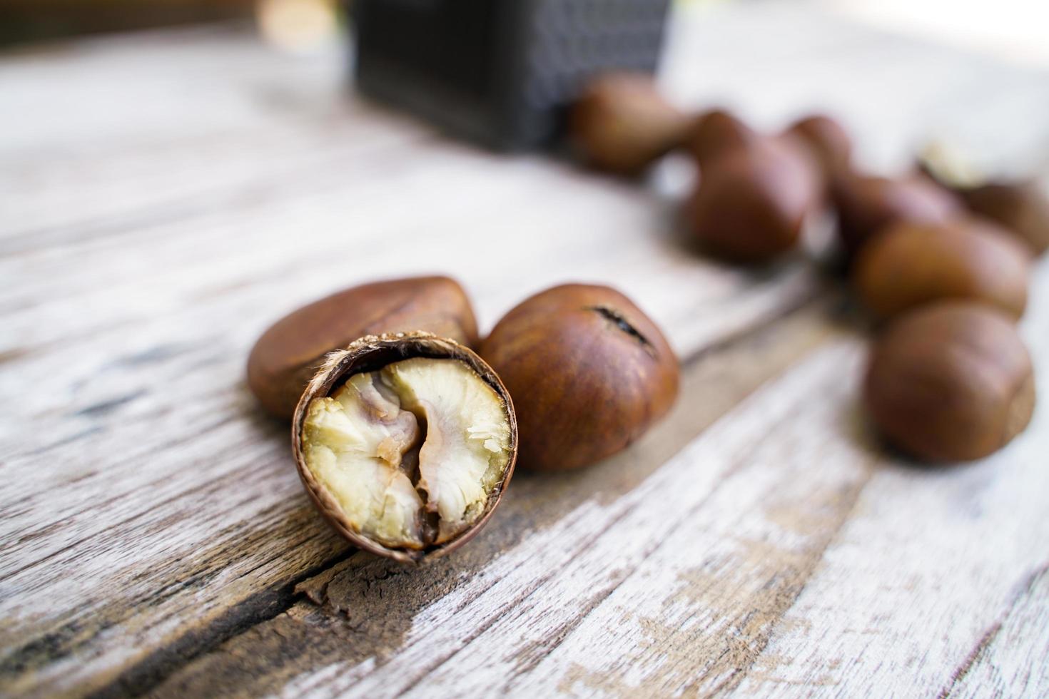 Fresh chestnuts isolated on a wooden floor, chestnuts have an oily sweet taste. photo