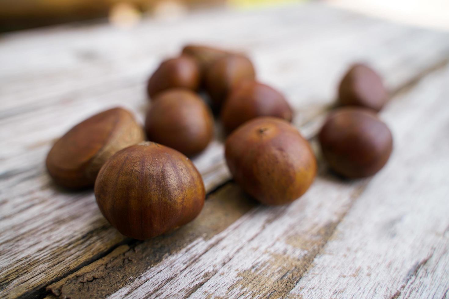 Fresh chestnuts isolated on a wooden floor, chestnuts have an oily sweet taste. photo