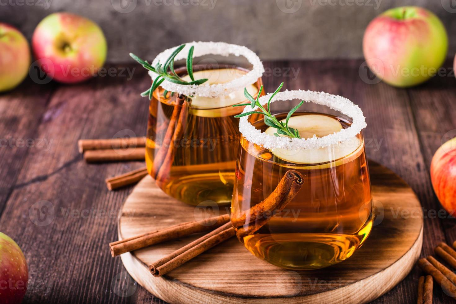 sidra de manzana orgánica casera con canela y romero en vasos sobre la mesa foto