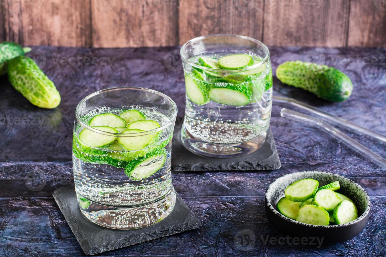 Cucumber mineral water in glasses on the table. Homemade antioxidant drinks photo