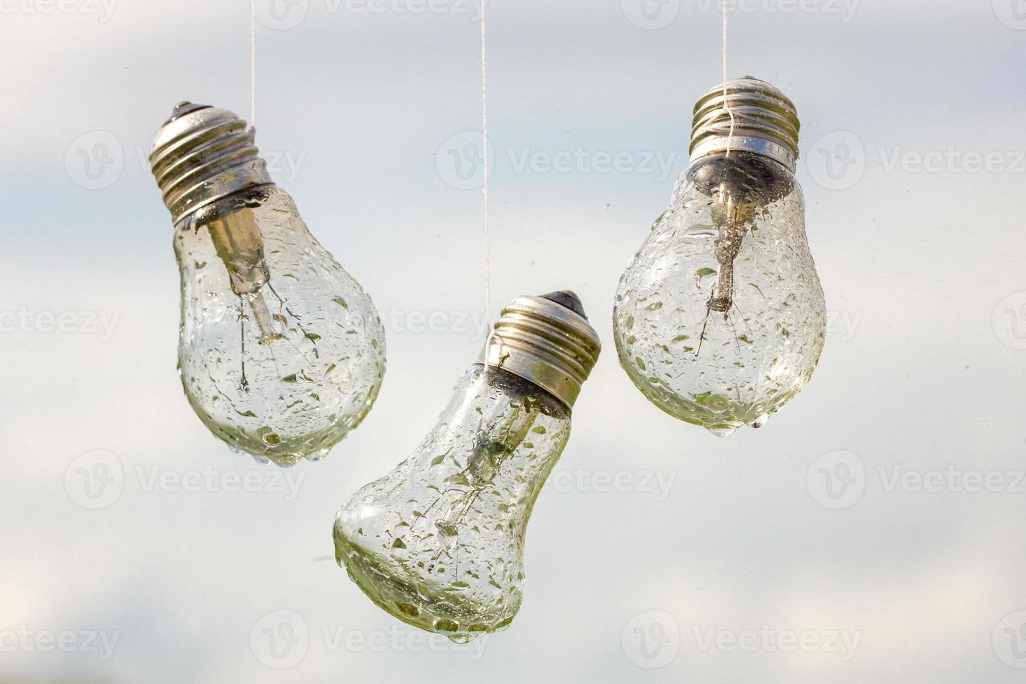 light bulbs hang in the rain, abstraction photo