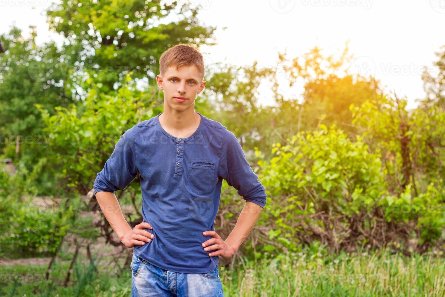 portrait of a young guy on a natural green background photo