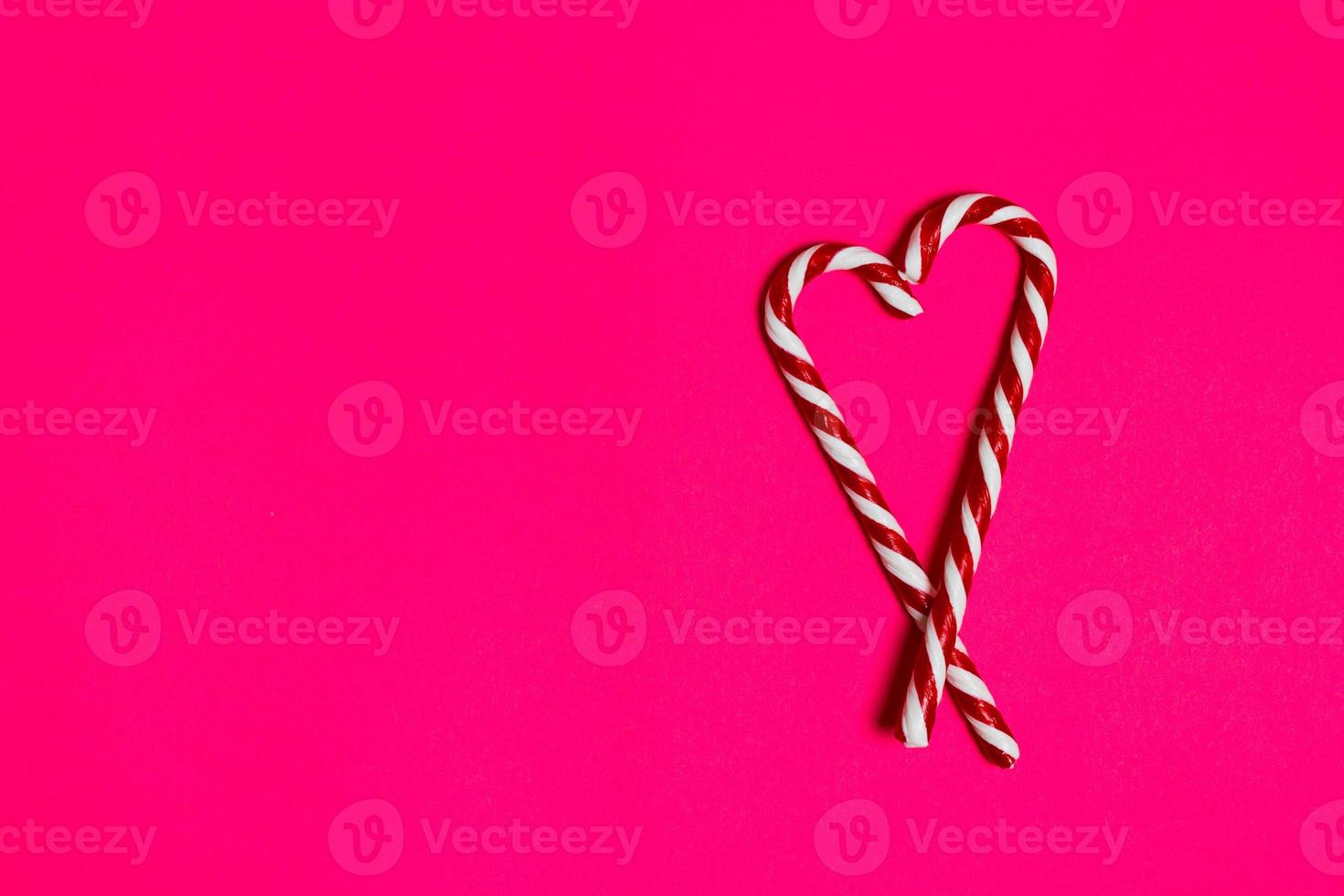 christmas candy heart on pink background. copy space photo