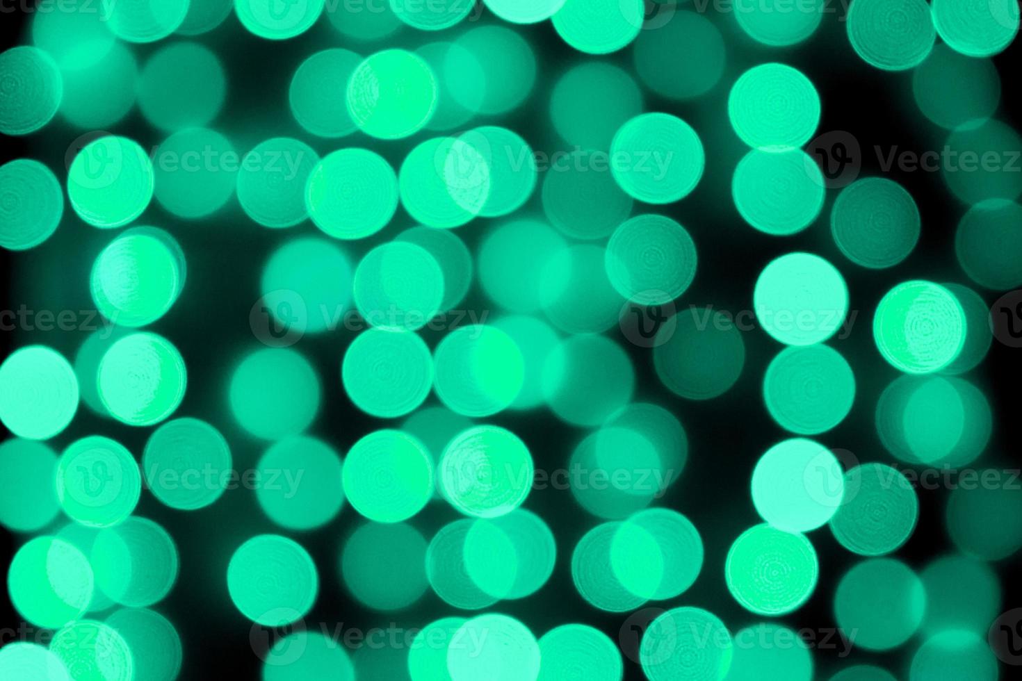 Unfocused abstract colourful bokeh black background. defocused and blurred many round blue light photo