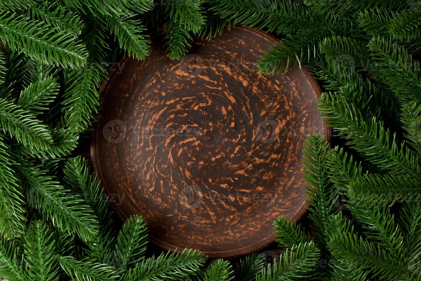Top view served plate with green fir tree branches. Holiday dinner concept with copy space photo