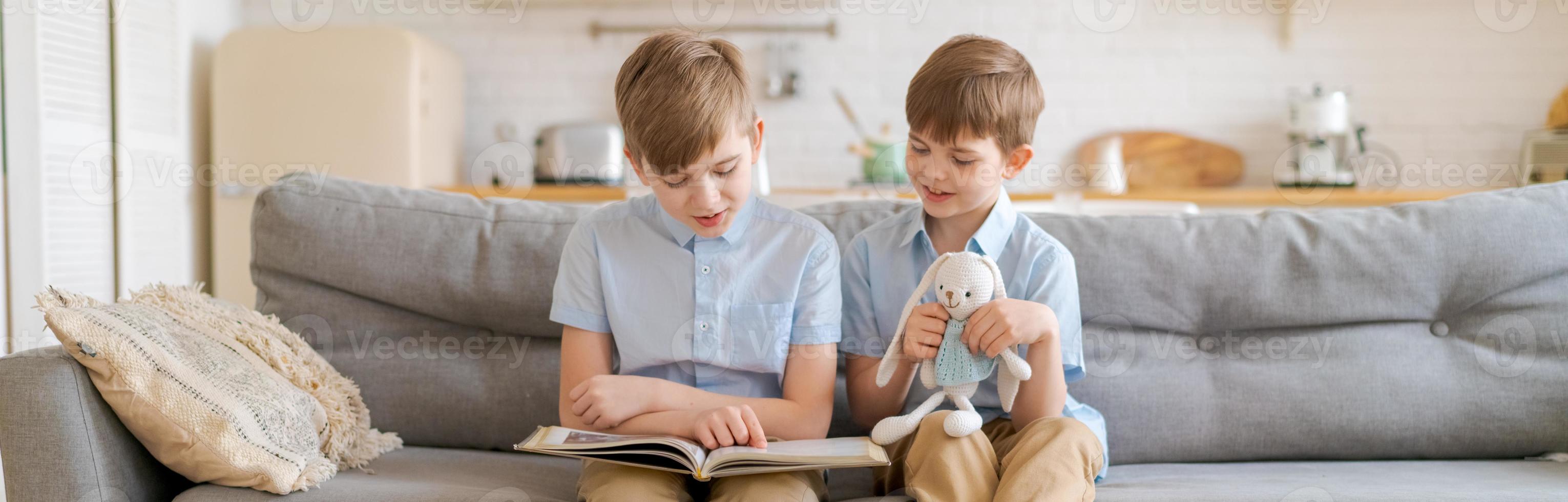 Teach your child to read book as teenager. Caucasian child looking into book photo