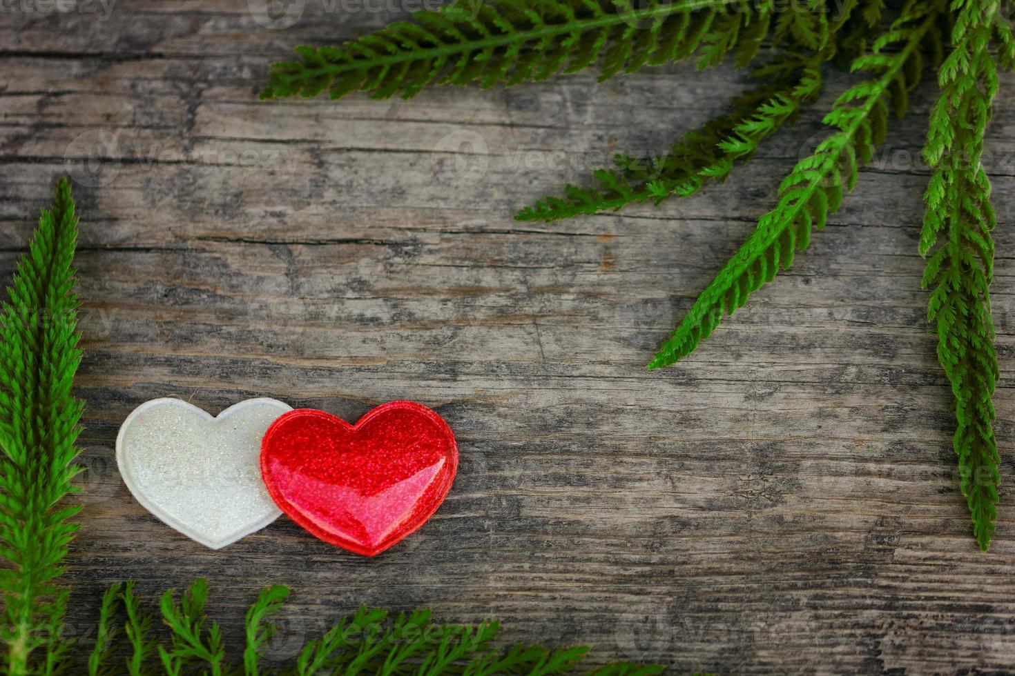 red and white heart lie on wooden background, the concept of romance and love photo