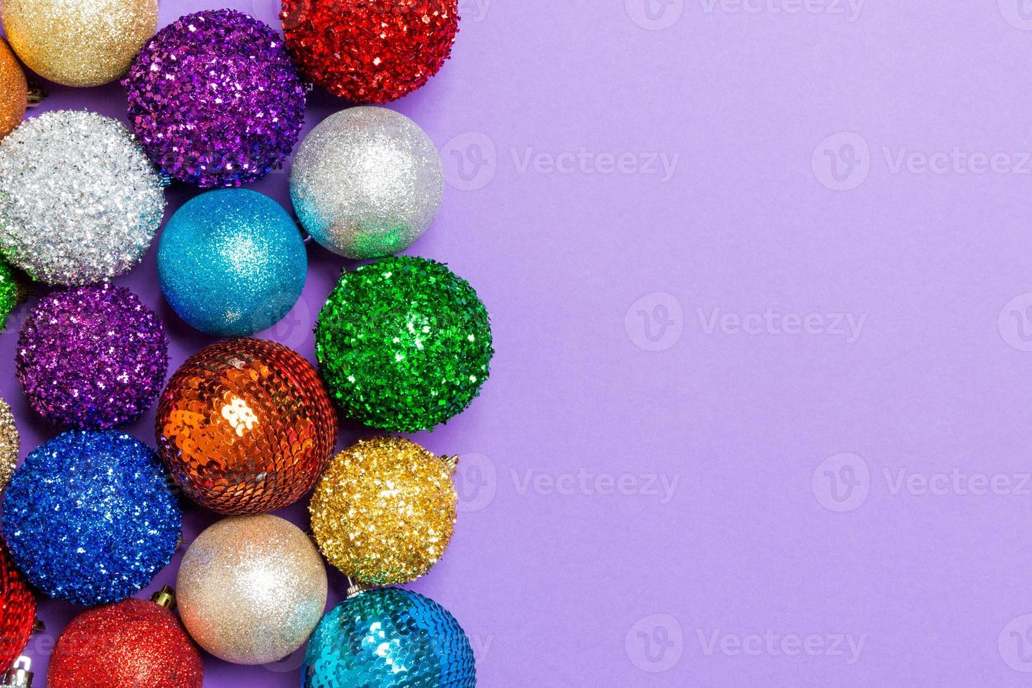 Festive composition of decorative baubles on colorful background. Top view of Christmas toys with copy space photo