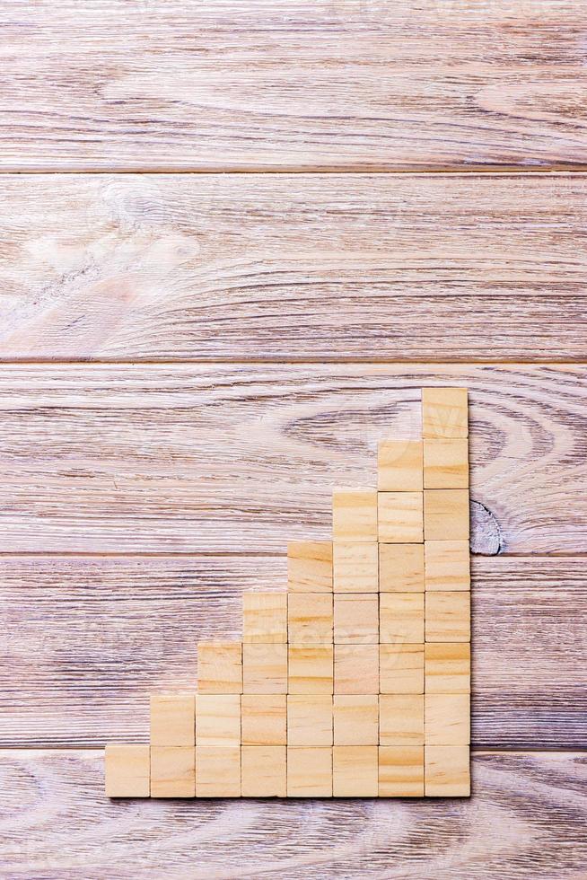 A wooden blocks cube over black wooden textured background with copy space for add word text title. Concept or conceptual Wood block stair or eight steps. Cubic photo