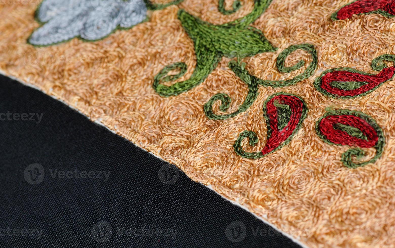 A closeup shot of national ornaments and patterns of Central Asia on a piece of fabric photo