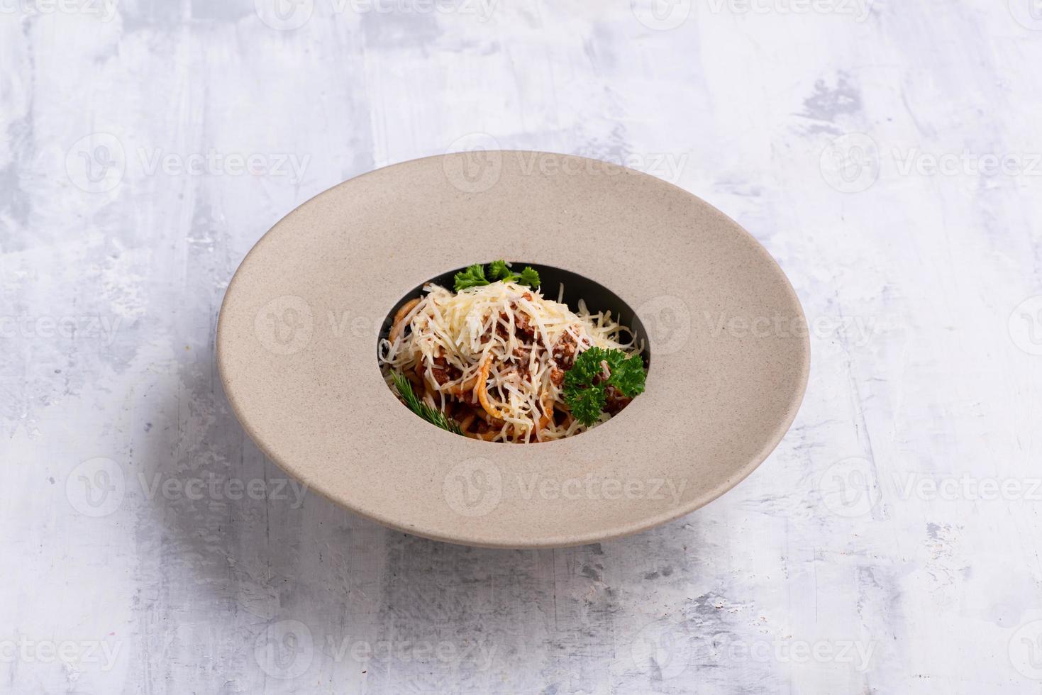 A closeup of a tasty white soup on a table hand tossing in herbs photo