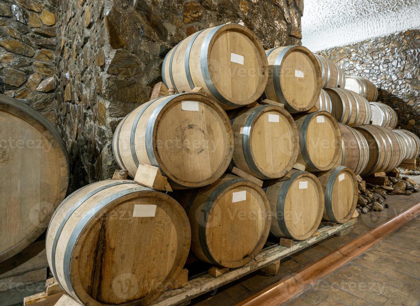 The wooden wine barrels in a wine factory photo