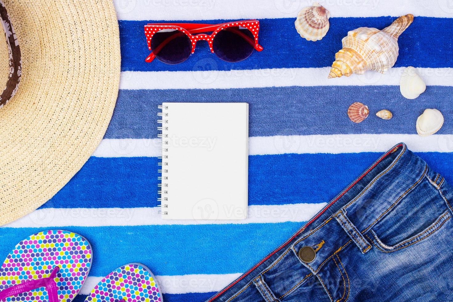 Summer accessories with notebook and copy space. Top view and selective focus photo