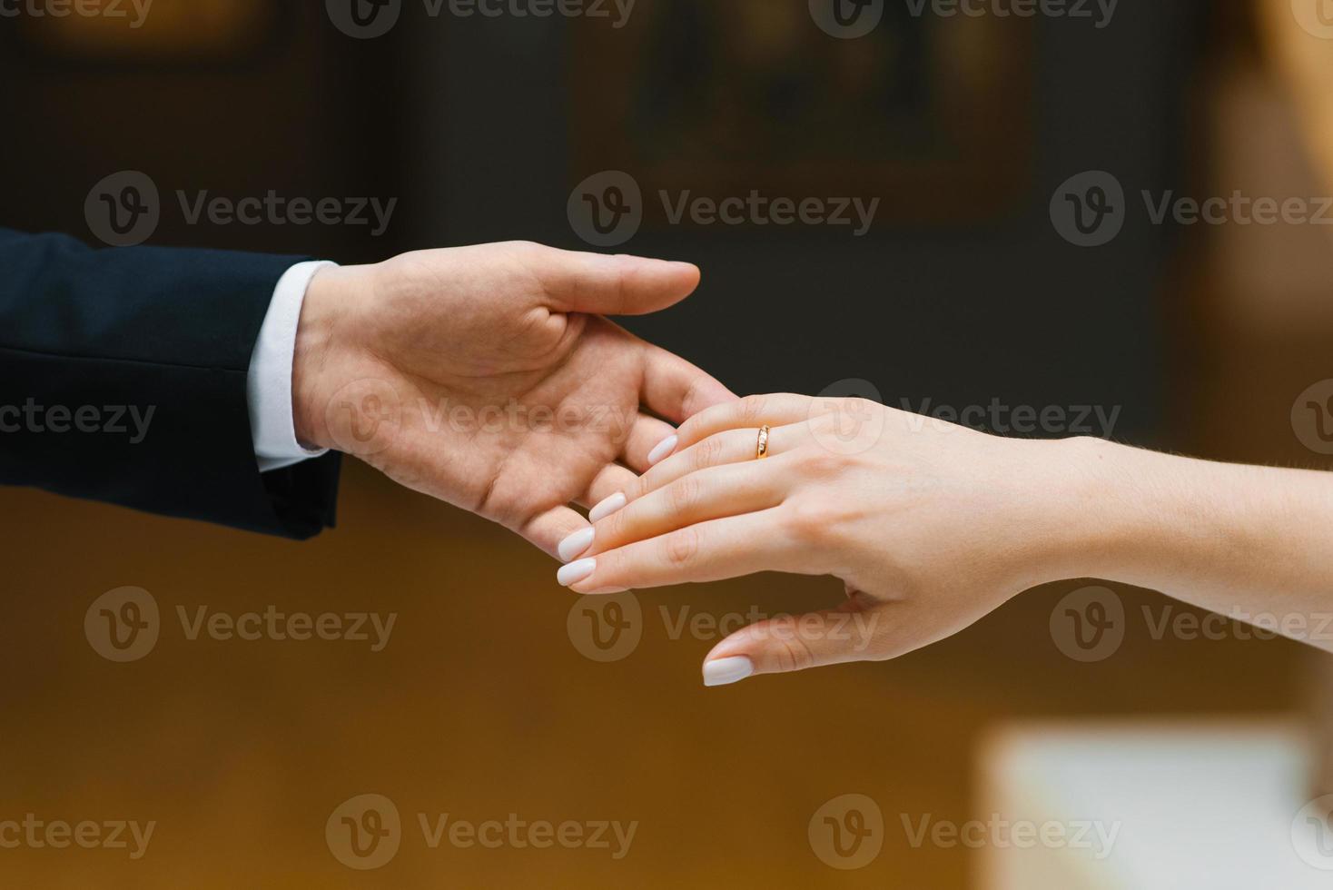 The groom extends his hand to the bride. Close-up photo