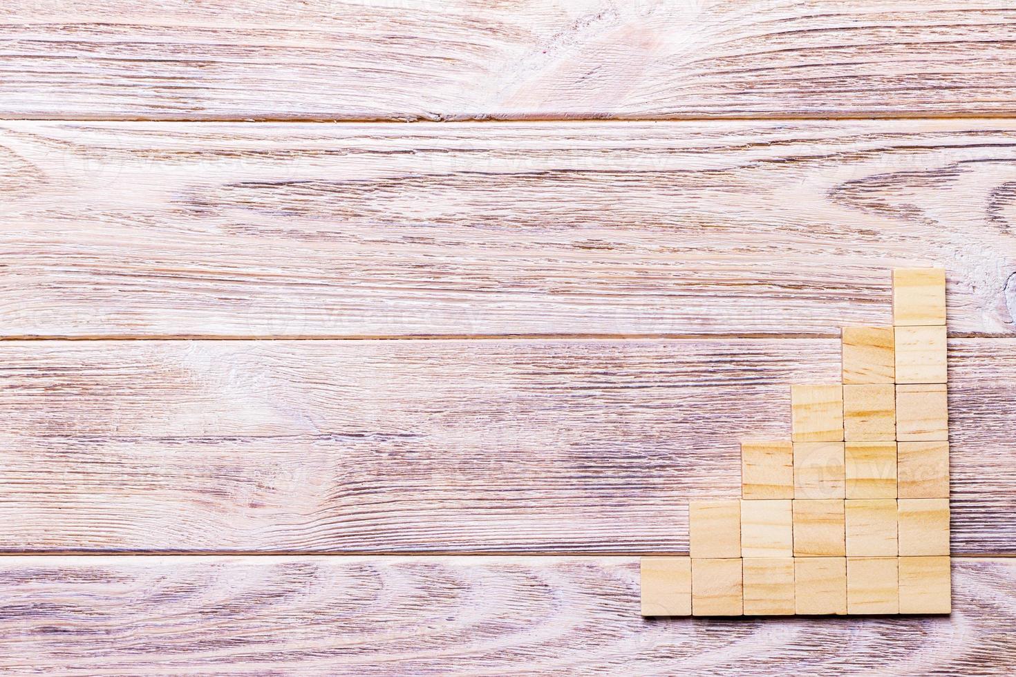 A wooden blocks cube over black wooden textured background with copy space for add word text title. Concept or conceptual Wood block stair or six steps. Cubic photo