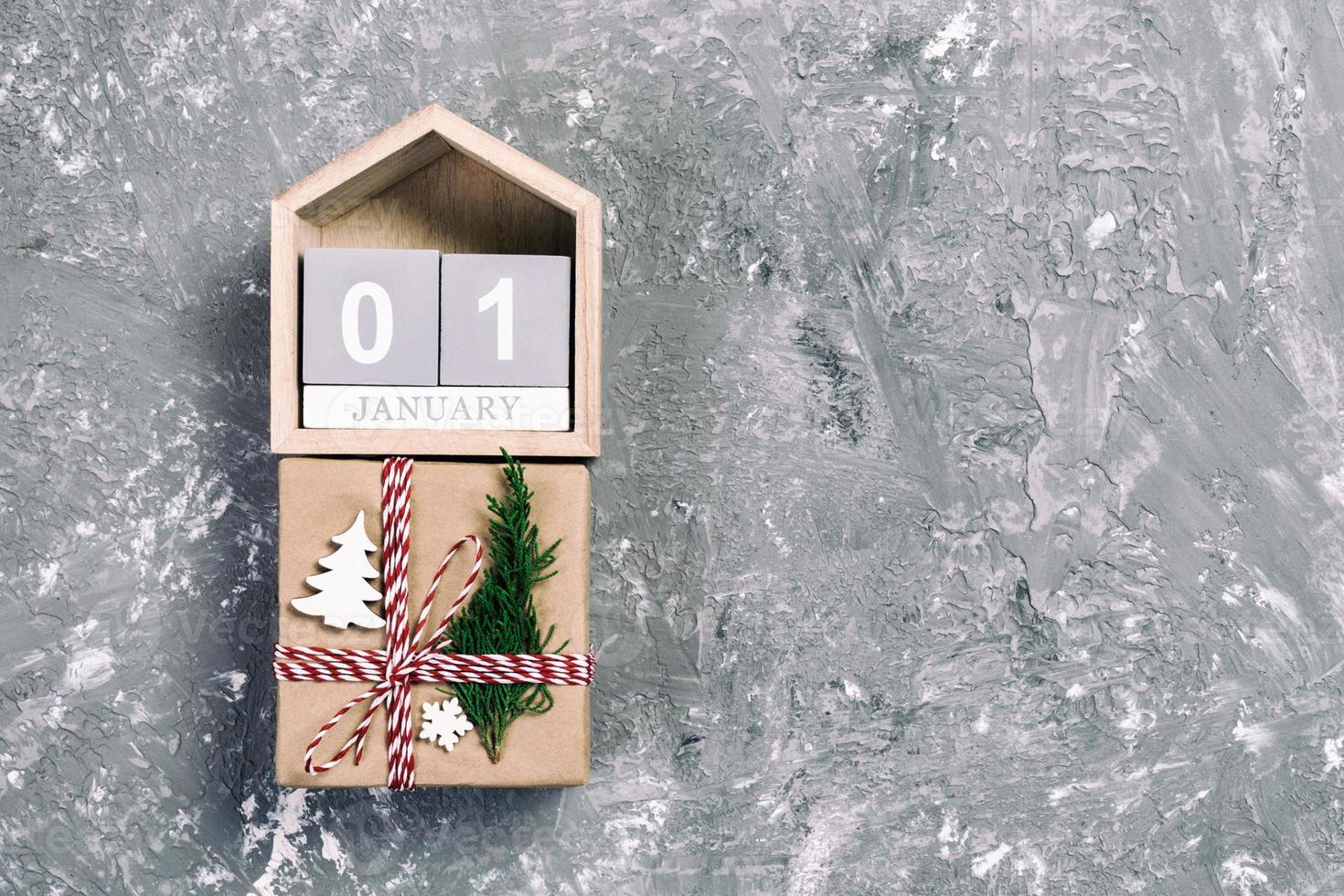Christmas calendar 1 january. Christmas gift, fir branches on vintage, toned wooden white background. Copy space, top view photo