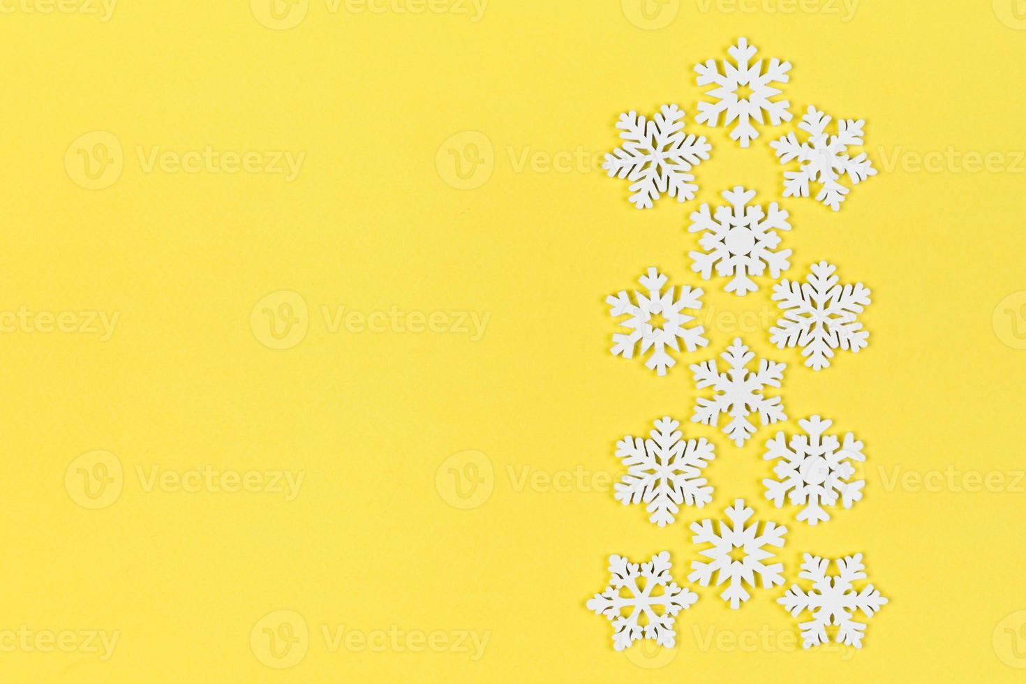 Top view of white snowflakes on colorful background. Winter weather concept with copy space. Merry Christmas concept photo