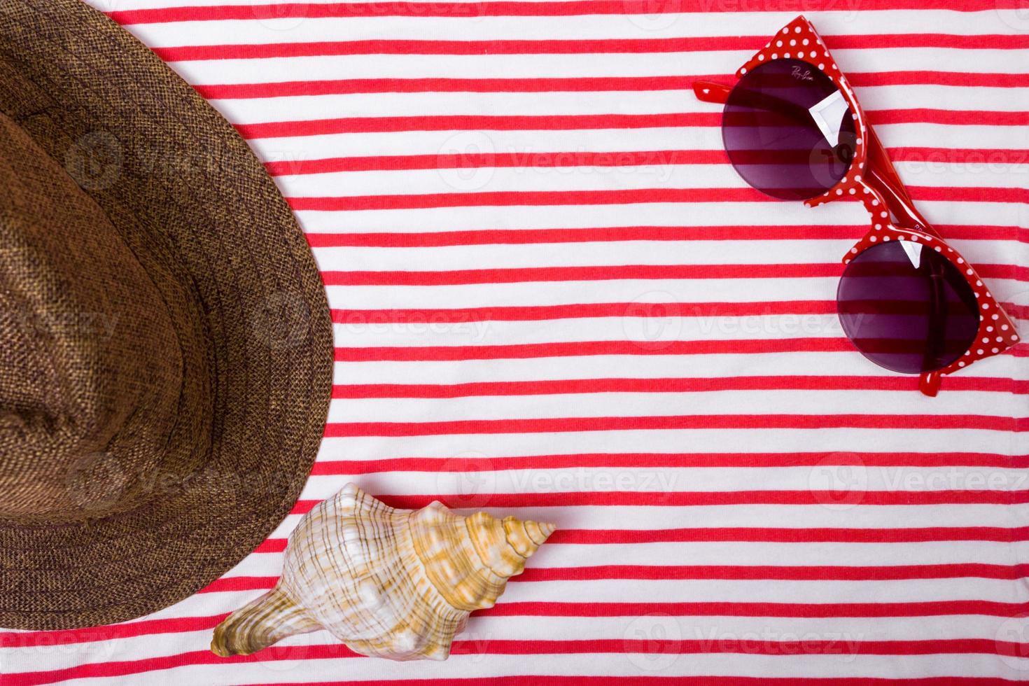 Summer vacation, tourism, travel, holiday concept. Sea shells, beach hat and striped blanket in white. Top view with space for text. photo