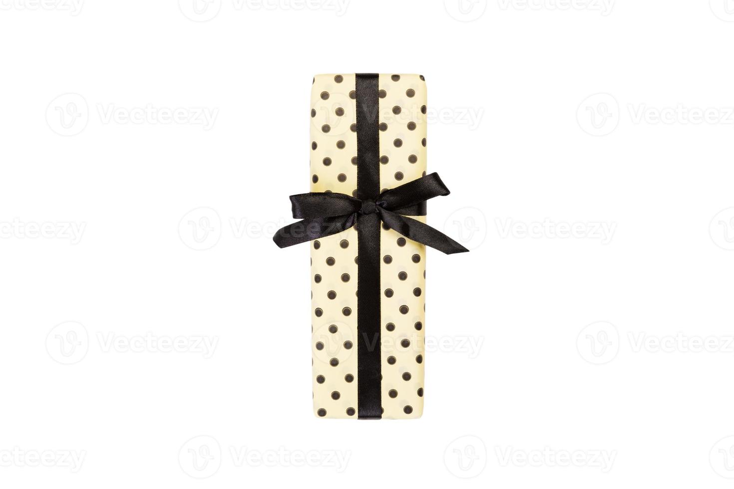 Christmas or other holiday handmade present in yellow paper with black ribbon. Isolated on white background, top view. thanksgiving Gift box concept photo