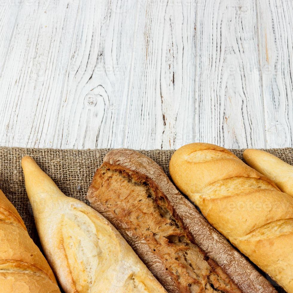 Homemade baguettes on wooden table. close up photo