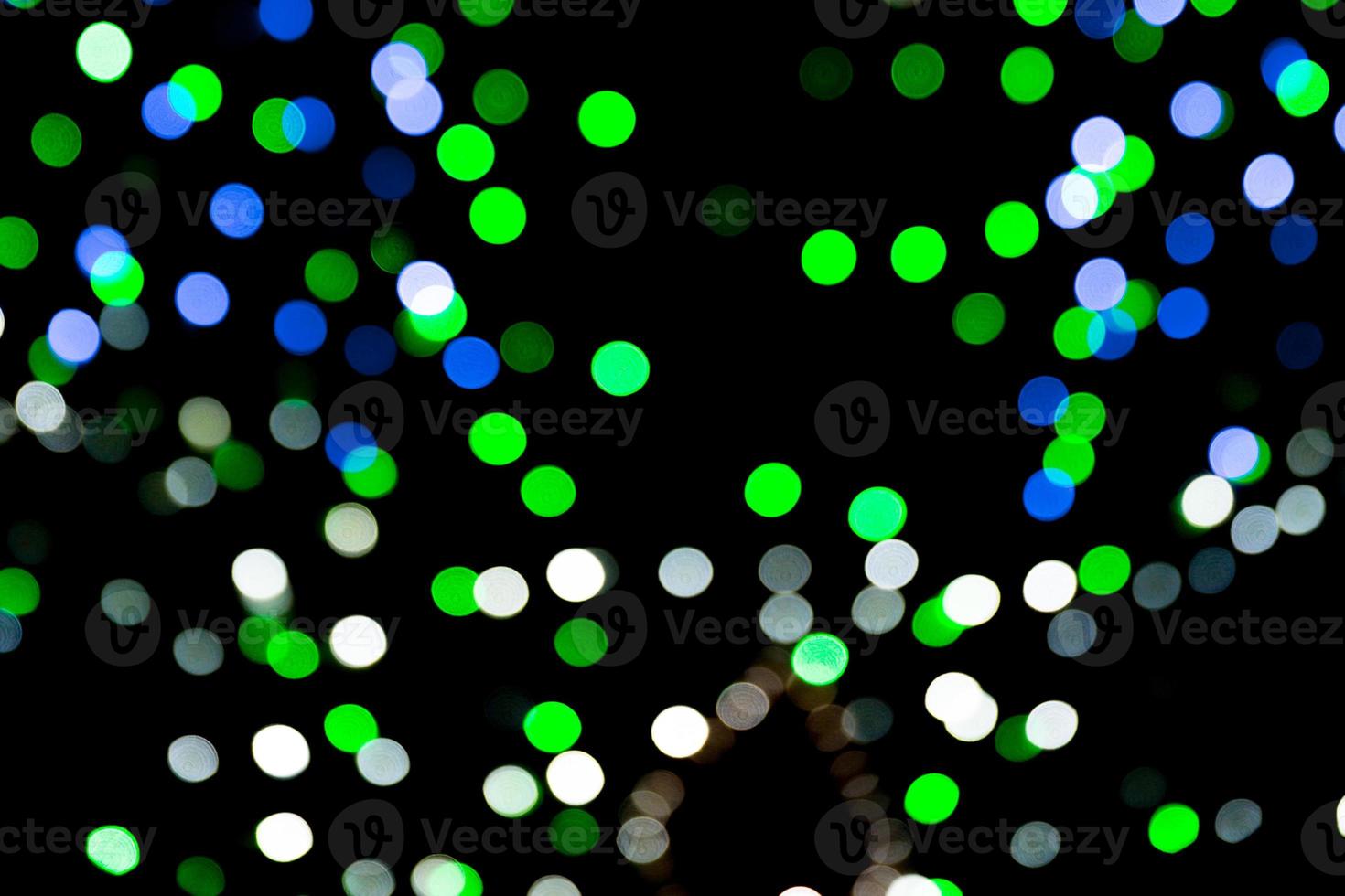 Unfocused abstract colourful bokeh on black background. defocused and blurred many round light photo